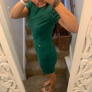 Green dress with gold buttons and faux pockets